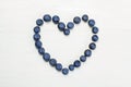 BLUEBERRIES HEART SHAPED WHITE WOOD BACKGROUND