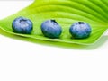 Blueberries on a leaf. on a white background. stack of blueberries with green leaves isolated on white background Royalty Free Stock Photo