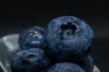 Blueberries Macro closeup photo of superimposed on top of each other and tiled in a teaspoon against a dark background