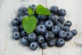 Blueberries and mint leaves close up on wooden background Royalty Free Stock Photo