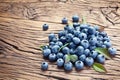 Blueberries over old wooden table.