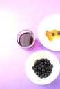 Blueberries, pulp in syrup. Blueberry juice on purple background. Royalty Free Stock Photo