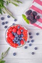 Blueberries, raspberries, blackberry and red currant in a bowls on a wooden background. Top view Royalty Free Stock Photo