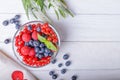 Blueberries, raspberries and red currant in a bowl on a wooden background. Top view, free space Royalty Free Stock Photo