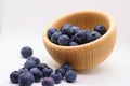 Blueberries spilling out of wooden bowl Royalty Free Stock Photo
