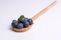 Blueberries on wooden spoon on white background Royalty Free Stock Photo