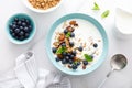 Blueberry and almond granola with greek yogurt, cottage cheese and fresh berries