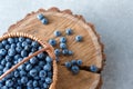 Blueberry in basket on wooden table background. Ripe and juicy fresh picked blueberries closeup, top view Royalty Free Stock Photo