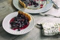 Blueberry and blackberry tart. Freshly baked dark berry pie, shown on a rustic table.