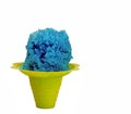 Blue Hawaiian Shave ice, Shaved ice or snow cone dessert in a yellow flower shaped cup.