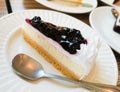 Blueberry Cheese Pie and silver spoon on white porcelain dish