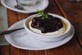 Blueberry cheese pie in white dish put on a wooden table. Royalty Free Stock Photo