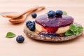 Blueberry cheesecake with fresh mint leaves on wooden background