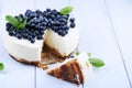 Blueberry cheesecake on a white wooden background