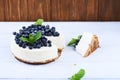 Blueberry cheesecake on a white wooden background