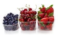 Blueberry, cherry and strawberry in plastic container box isolated on white Royalty Free Stock Photo