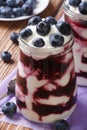 Blueberry cream in glass jar closeup vertical