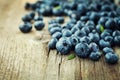 Blueberry, great bilberry or bog whortleberry on wooden board Royalty Free Stock Photo