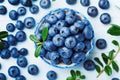 Blueberry or great bilberry in bowl on blue wooden background top view. Organic superfood and healthy nutrition. Royalty Free Stock Photo