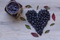 Blueberry heart on wooden background; Healthy life symbol; Blueberry jam