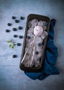 Blueberry ice cream, container with a spoon, on a gray table, fresh blueberries, Royalty Free Stock Photo