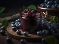 Blueberry jam in a glass jar and fresh berries on a dark background Royalty Free Stock Photo