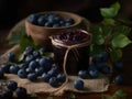 Blueberry jam in a glass jar and fresh berries on a dark background Royalty Free Stock Photo