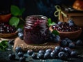 Blueberry jam in a glass jar and fresh berries on a dark background Royalty Free Stock Photo