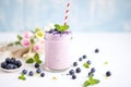 blueberry milkshake with fresh blueberries and mint sprig