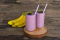 Blueberry Juice and Banana smoothies, a tasty healthy drink in a glass, drink the morning on a wooden background. Royalty Free Stock Photo