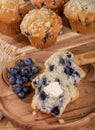 Blueberry Muffin and Spoonful of Berries on a Wooden Plate Royalty Free Stock Photo