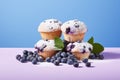 Blueberry muffins with berry fruits on blue background Royalty Free Stock Photo