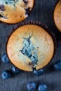 Blueberry muffins and fresh berries on wooden table Royalty Free Stock Photo