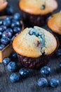 Blueberry muffins and fresh berries on wooden table Royalty Free Stock Photo