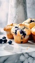 Blueberry muffins with fresh berriesle table. Square image.