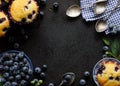 Blueberry muffins and fresh blueberries on a black background with copy space, top view Royalty Free Stock Photo