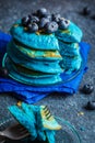Blueberry blueberry pancakes with coconut chips on dark background