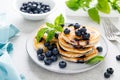 Blueberry pancakes with fresh berries on breakfast table