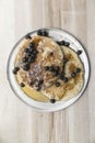 Blueberry pancakes with maple syrup on a metal plate on a wooden table. Royalty Free Stock Photo