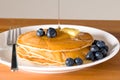 Blueberry pancakes on a plate with fork Royalty Free Stock Photo