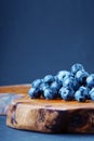 Blueberry on a picturesque wooden board.
