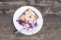 Blueberry pie strudel Close up shot on white plate on old wood Royalty Free Stock Photo