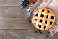 Blueberry pie, top view corner border over a rustic wood background Royalty Free Stock Photo