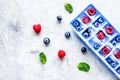 Blueberry and raspberry in ice tray on stone background top view Royalty Free Stock Photo