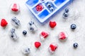 Blueberry and raspberry in ice tray on stone background top view Royalty Free Stock Photo