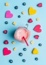 blueberry raspberry , mango, decorative hearts lined frame on a blue background, space for text with fresh smoothies with