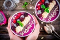 Blueberry smoothie bowl with banana, raspberry, pitaya, blackberry, almonds, sunflower and chia seeds