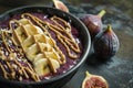 a blueberry smoothie bowl with bananas, nut butter and figues