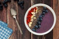 Blueberry smoothie bowl on a rustic wood table