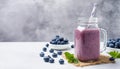 Blueberry smoothie in glass with paper straw. Tasty and healthy beverage. Delicious summer drink